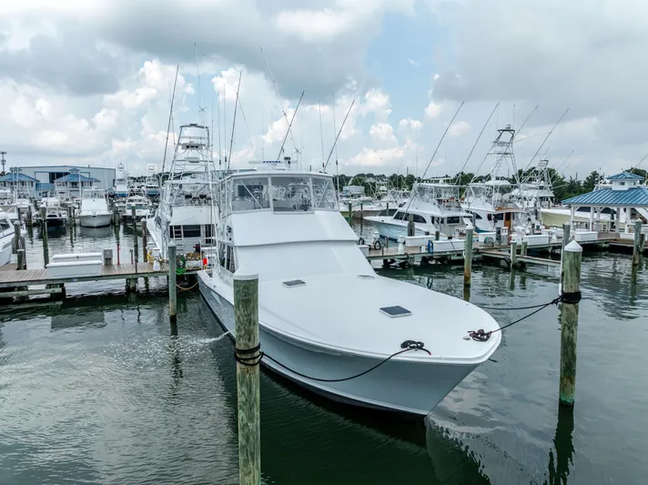 Second Chance Yacht Photos Pics A 1995 Viking 50 yacht docked at a marina under a cloudy sky.