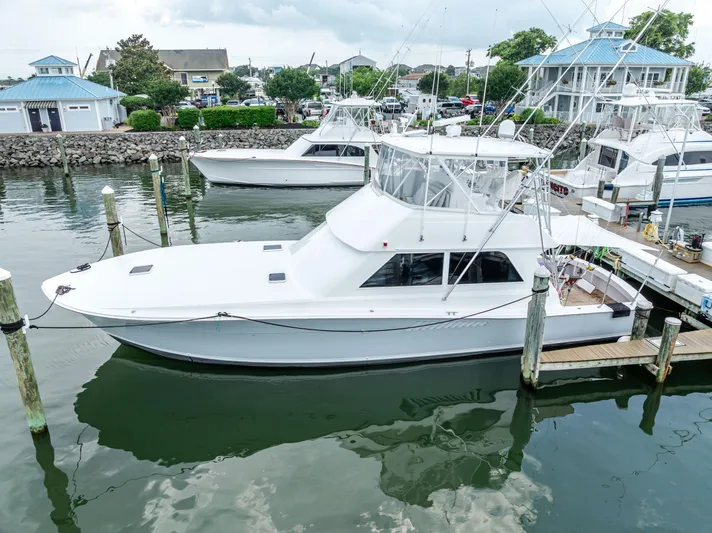 Second Chance Yacht Photos Pics 1995 Viking 50 yacht docked at a marina, surrounded by other boats and waterfront buildings.