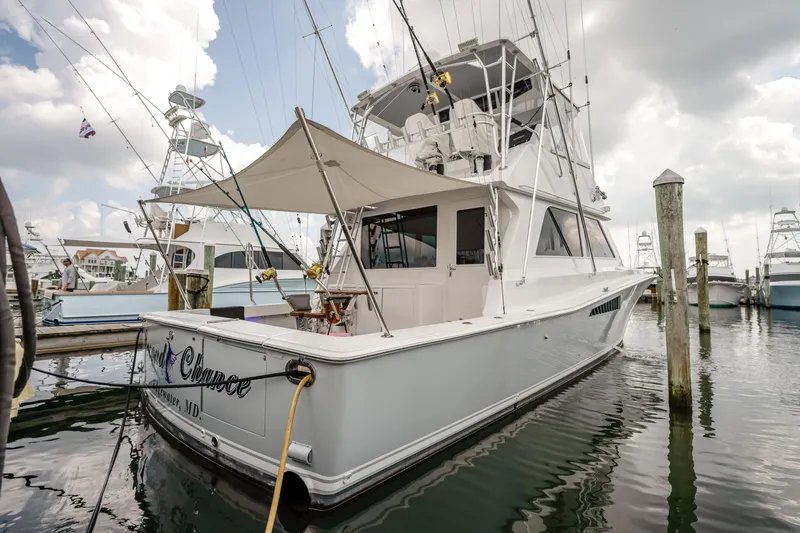 Second Chance Yacht Photos Pics 1995 Viking 50 yacht docked at marina under cloudy sky.