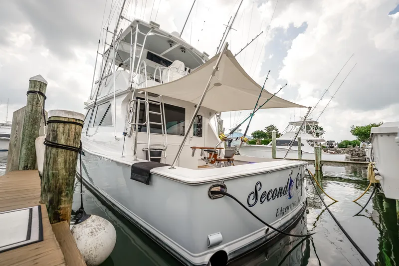 Second Chance Yacht Photos Pics 1995 Viking 50 yacht docked, featuring fishing rods and canopy, named "Second Chance."