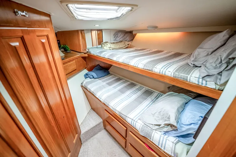 Second Chance Yacht Photos Pics Cozy bunk beds in a 1995 Viking 50 yacht cabin with wooden interior.