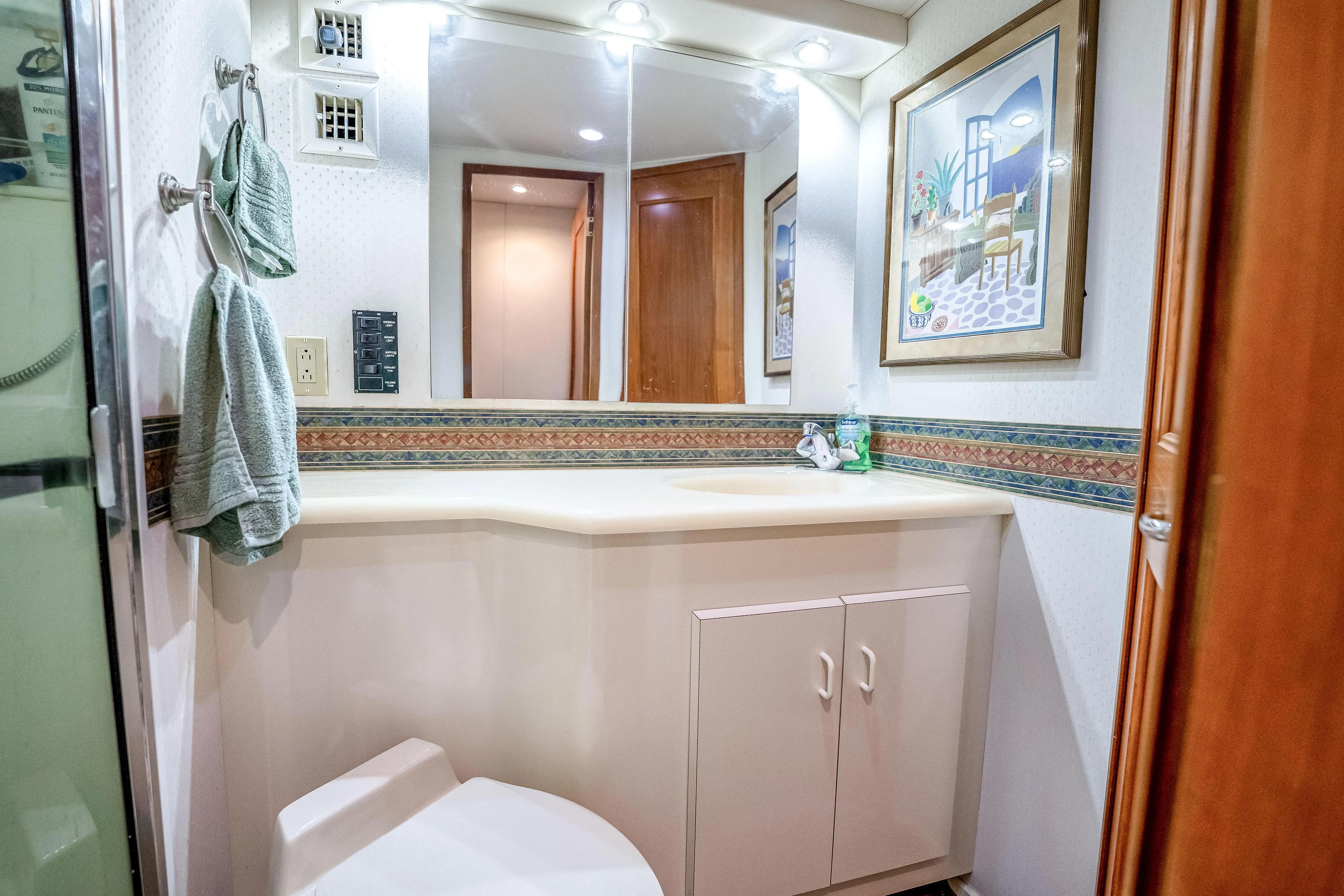 Second Chance Yacht Photos Pics Bathroom interior of a 1995 Viking 50 yacht with mirror, sink, and decorative elements.