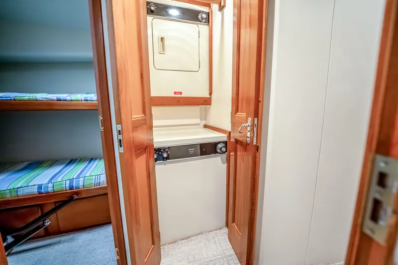 Second Chance Yacht Photos Pics Laundry area with washer-dryer in 1995 Viking 50 yacht, adjacent to bunk beds.