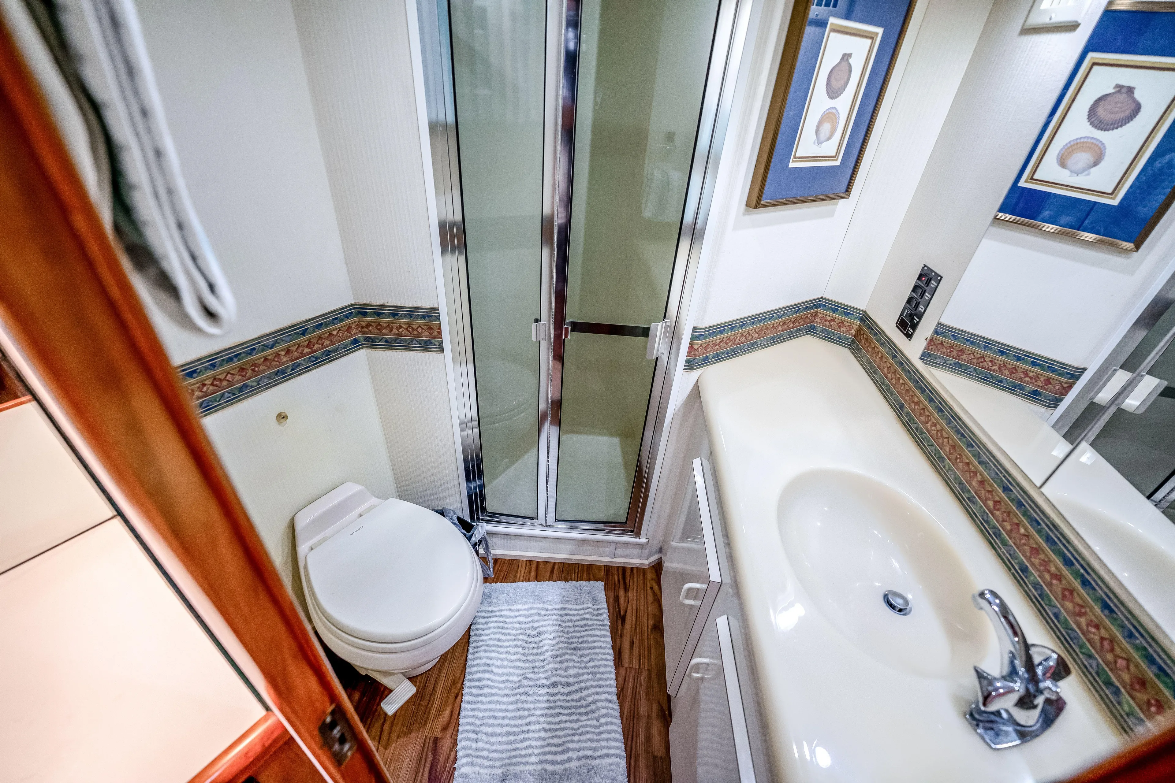 Second Chance Yacht Photos Pics Compact bathroom in a 1995 Viking 50 yacht with shower, toilet, and sink.