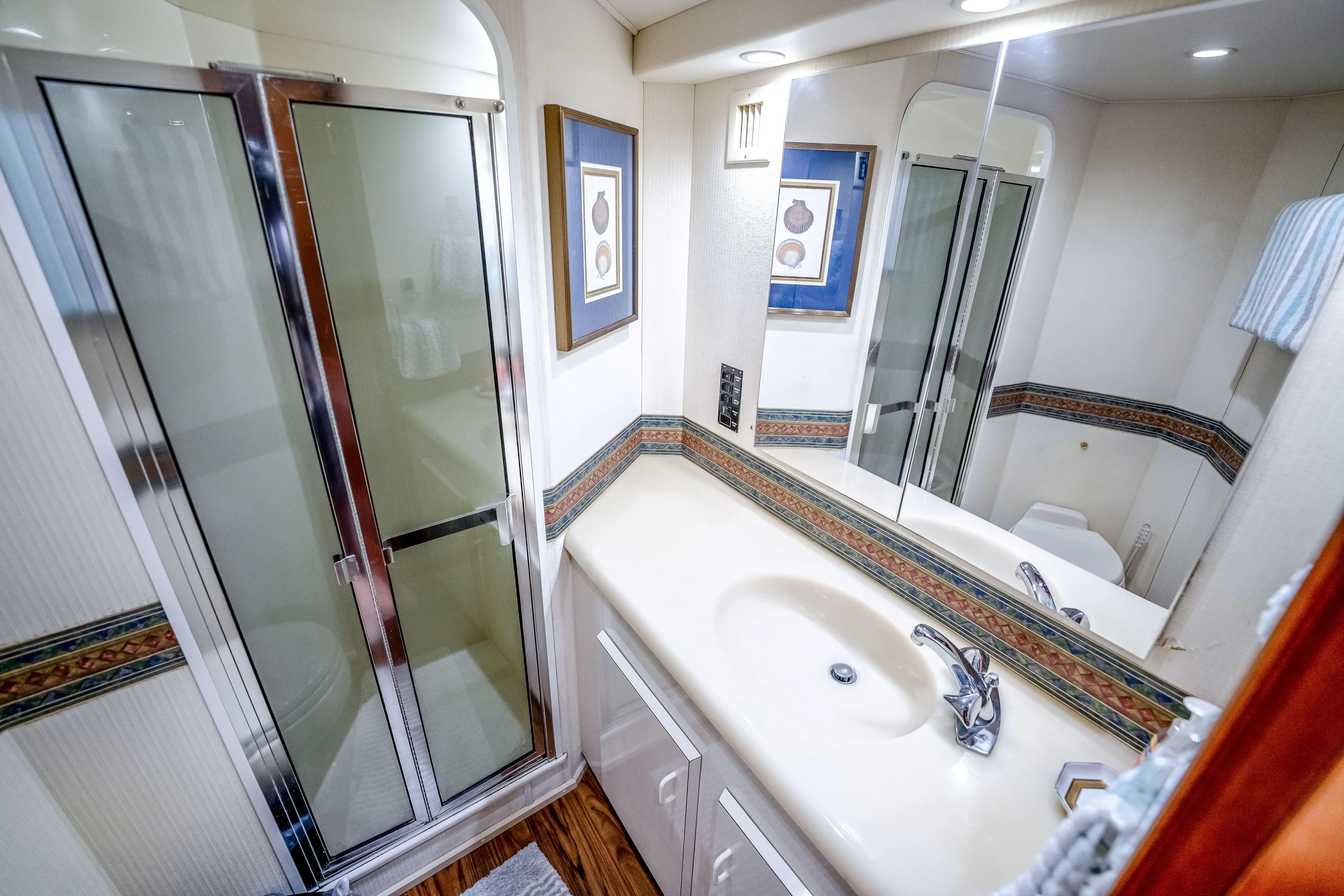 Second Chance Yacht Photos Pics Luxurious bathroom in 1995 Viking 50 yacht with shower, sink, and elegant decor.