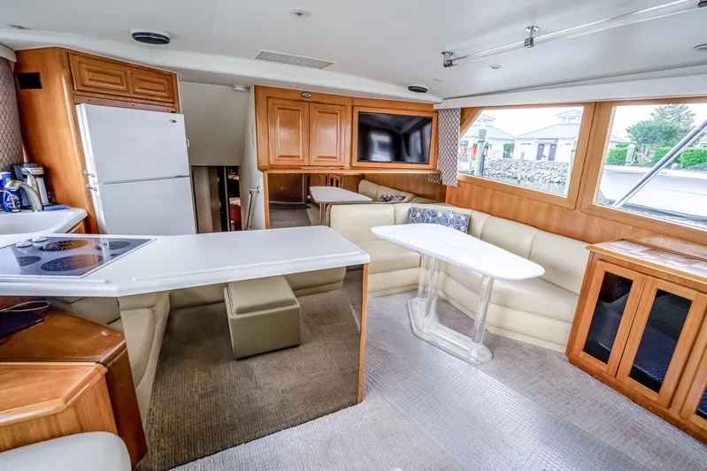 Second Chance Yacht Photos Pics Luxurious interior of a 1995 Viking 50 yacht with modern kitchen and seating area.