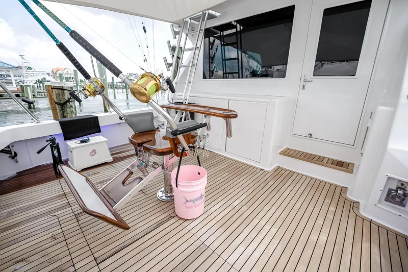 Second Chance Yacht Photos Pics 1995 Viking 50 yacht deck with fishing chair and rods, docked at marina.