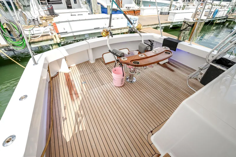 Second Chance Yacht Photos Pics Spacious deck of a 1995 Viking 50 yacht with wooden flooring and fishing equipment.