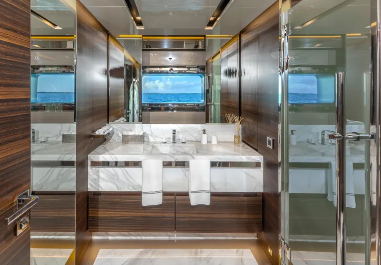 Safe Haven Yacht Photos Pics Luxurious yacht bathroom with marble sink, wooden accents, and ocean view window, Admiral Custom 2015.