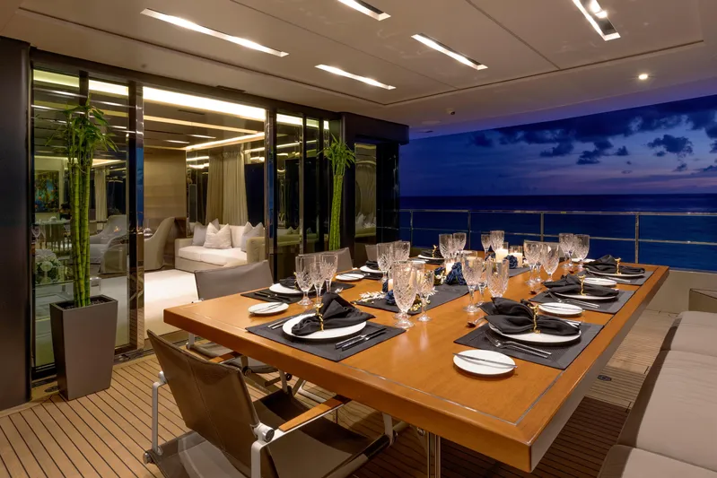 Safe Haven Yacht Photos Pics Luxurious dining area on 2015 Admiral Custom yacht with ocean view at sunset.