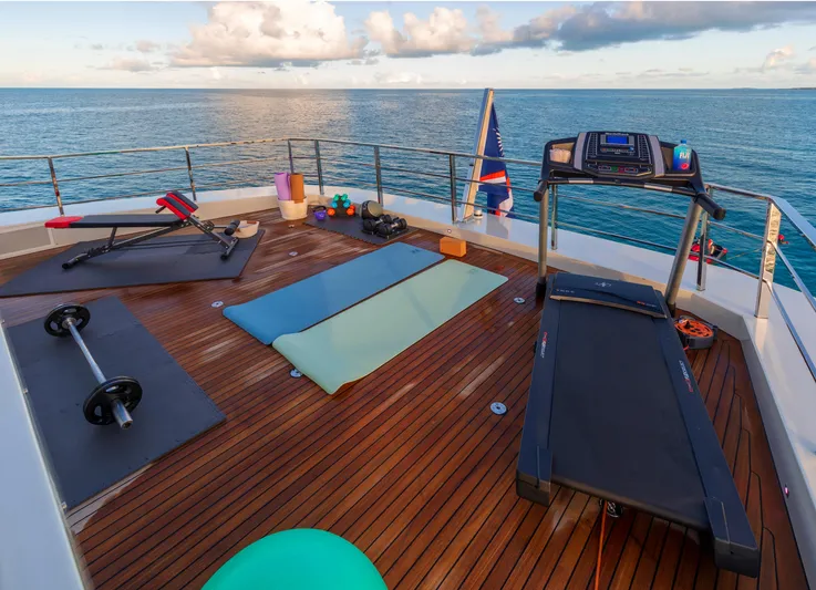 Safe Haven Yacht Photos Pics Outdoor gym on Admiral Custom yacht, 2015, with treadmill, weights, and ocean view.