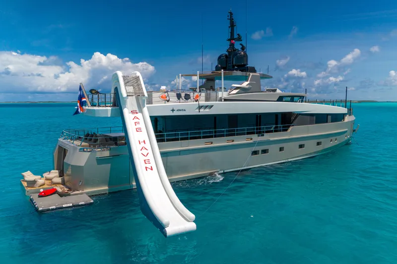 Safe Haven Yacht Photos Pics Luxury Admiral Custom 2015 yacht with slide, named "Safe Haven," in clear blue waters.