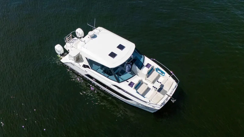 Yacht Photos Pics Aerial view of 2019 Aquila 36 Sport boat cruising on open water.