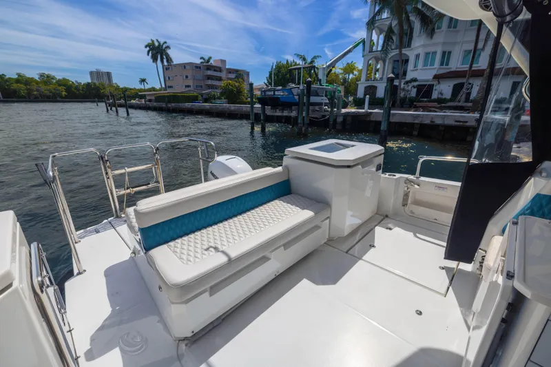  Yacht Photos Pics Aquila 36 Sport 2019 boat deck with seating, docked by waterfront homes.