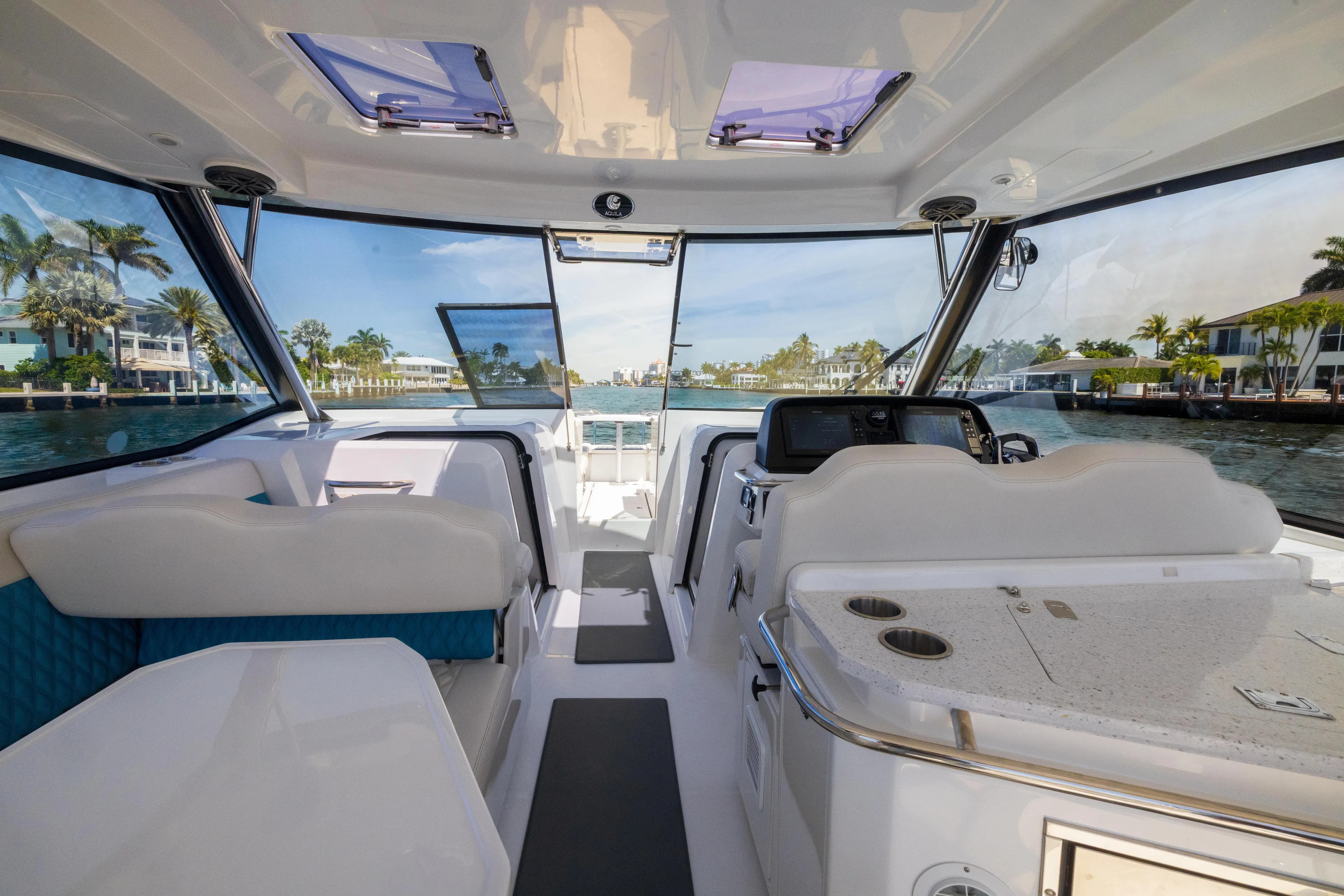  Yacht Photos Pics Interior view of 2019 Aquila 36 Sport boat with modern seating and dashboard.