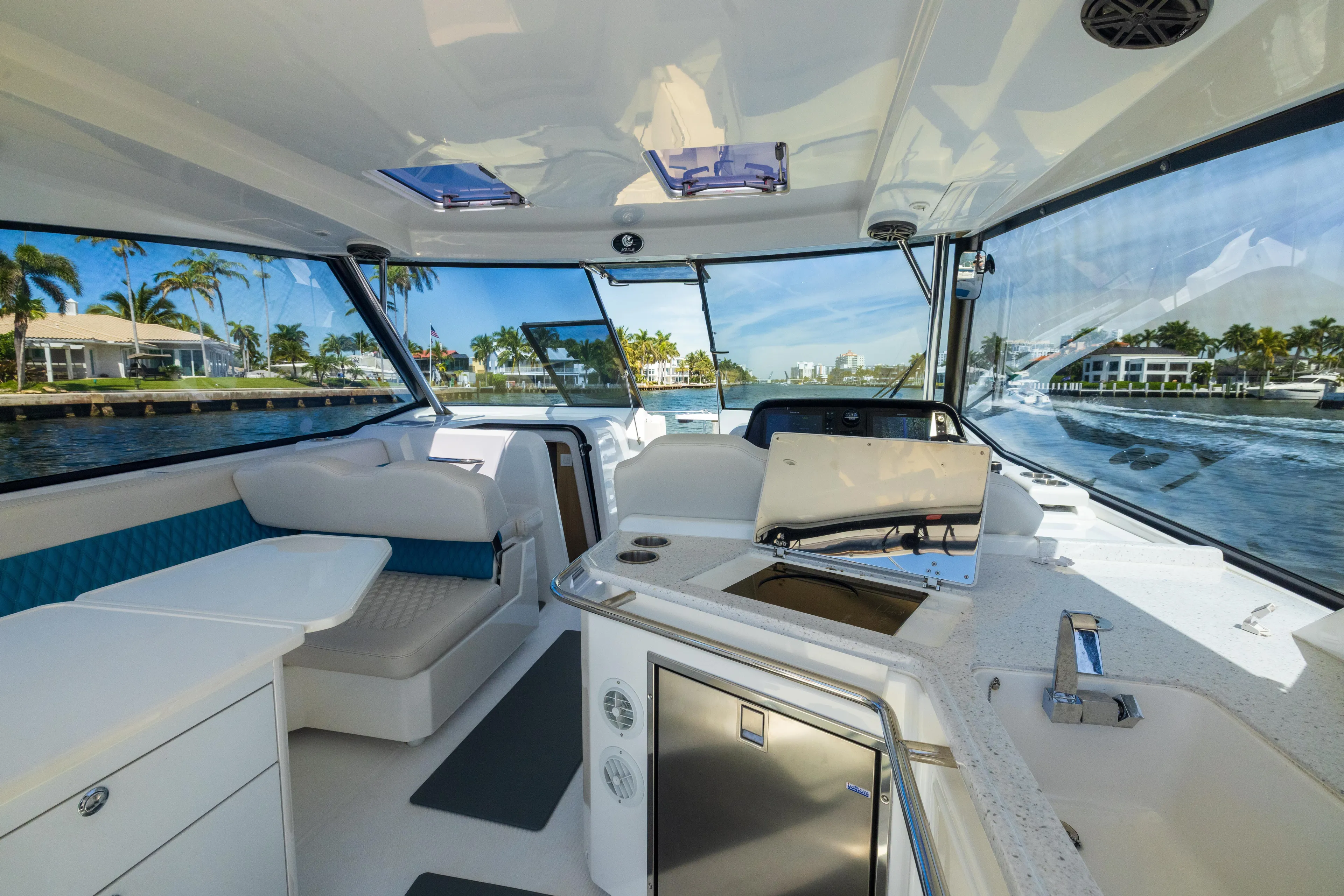  Yacht Photos Pics Interior of 2019 Aquila 36 Sport yacht with modern seating and kitchen area.