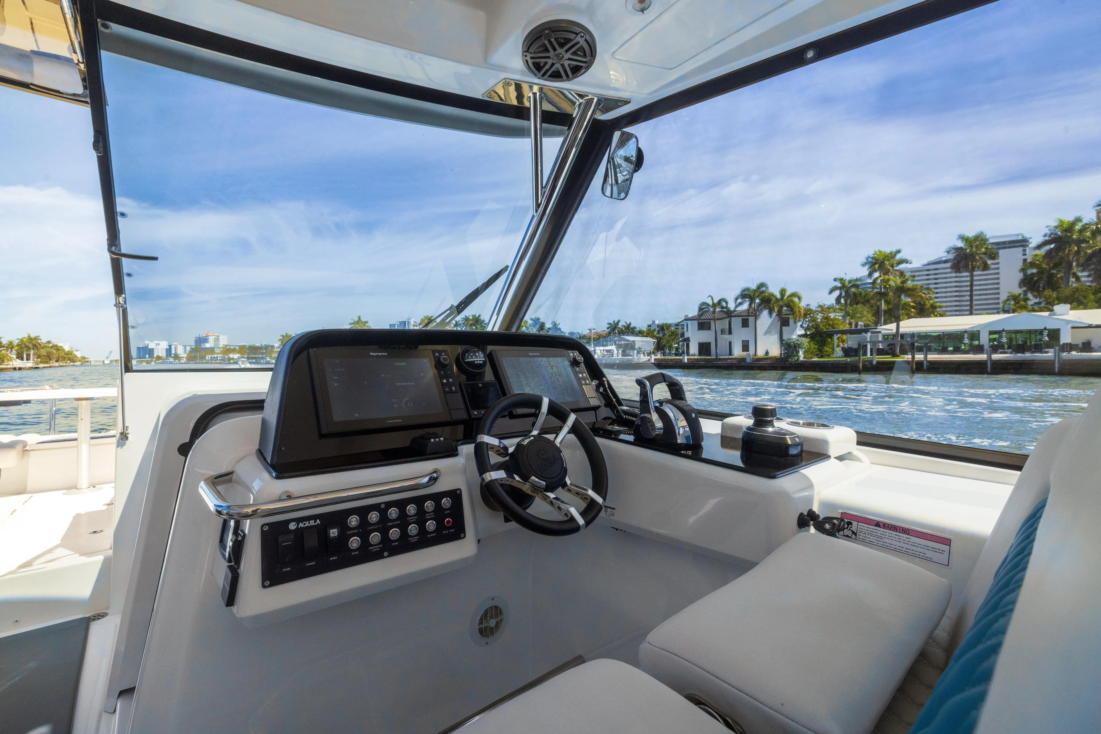  Yacht Photos Pics Interior view of 2019 Aquila 36 Sport boat with modern dashboard and waterfront scenery.