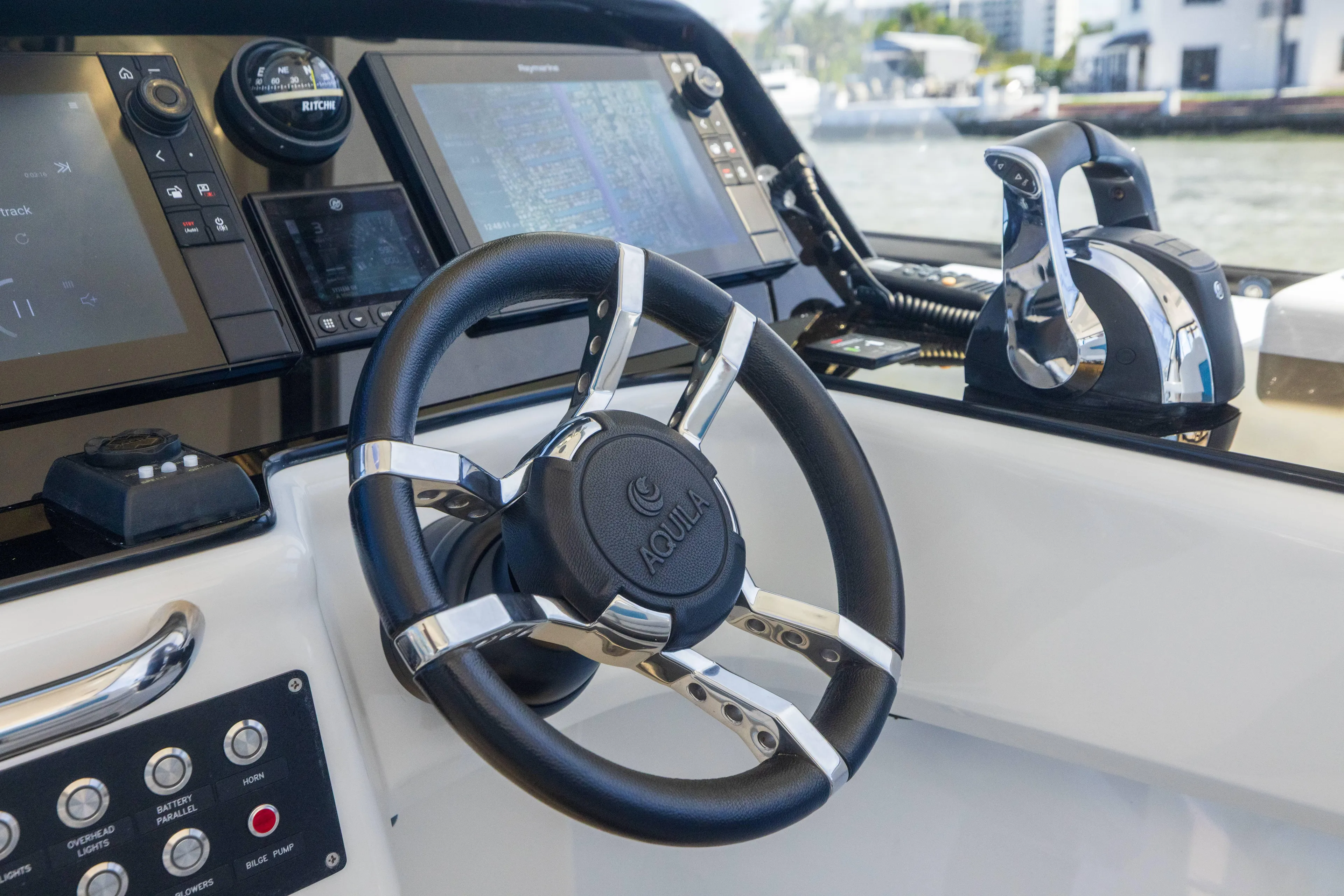  Yacht Photos Pics Steering console of 2019 Aquila 36 Sport boat with modern controls and navigation screens.