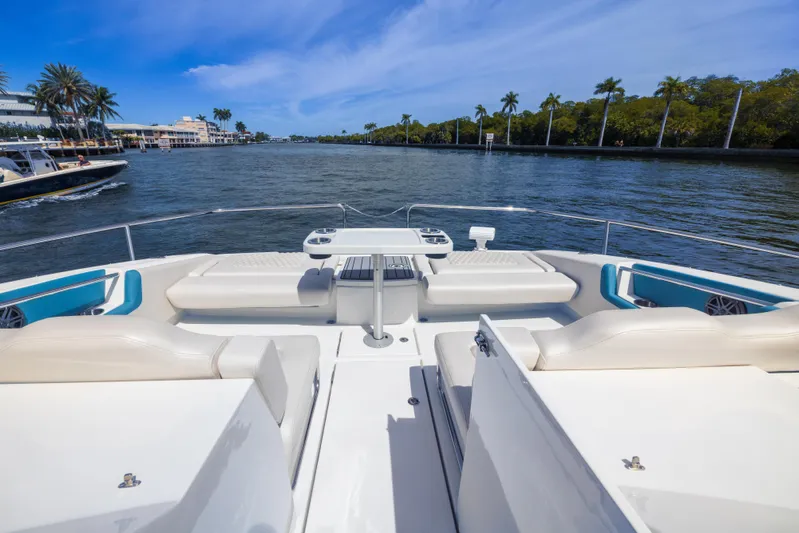  Yacht Photos Pics Aquila 36 Sport 2019 yacht with spacious deck and seating, cruising on a scenic waterway.