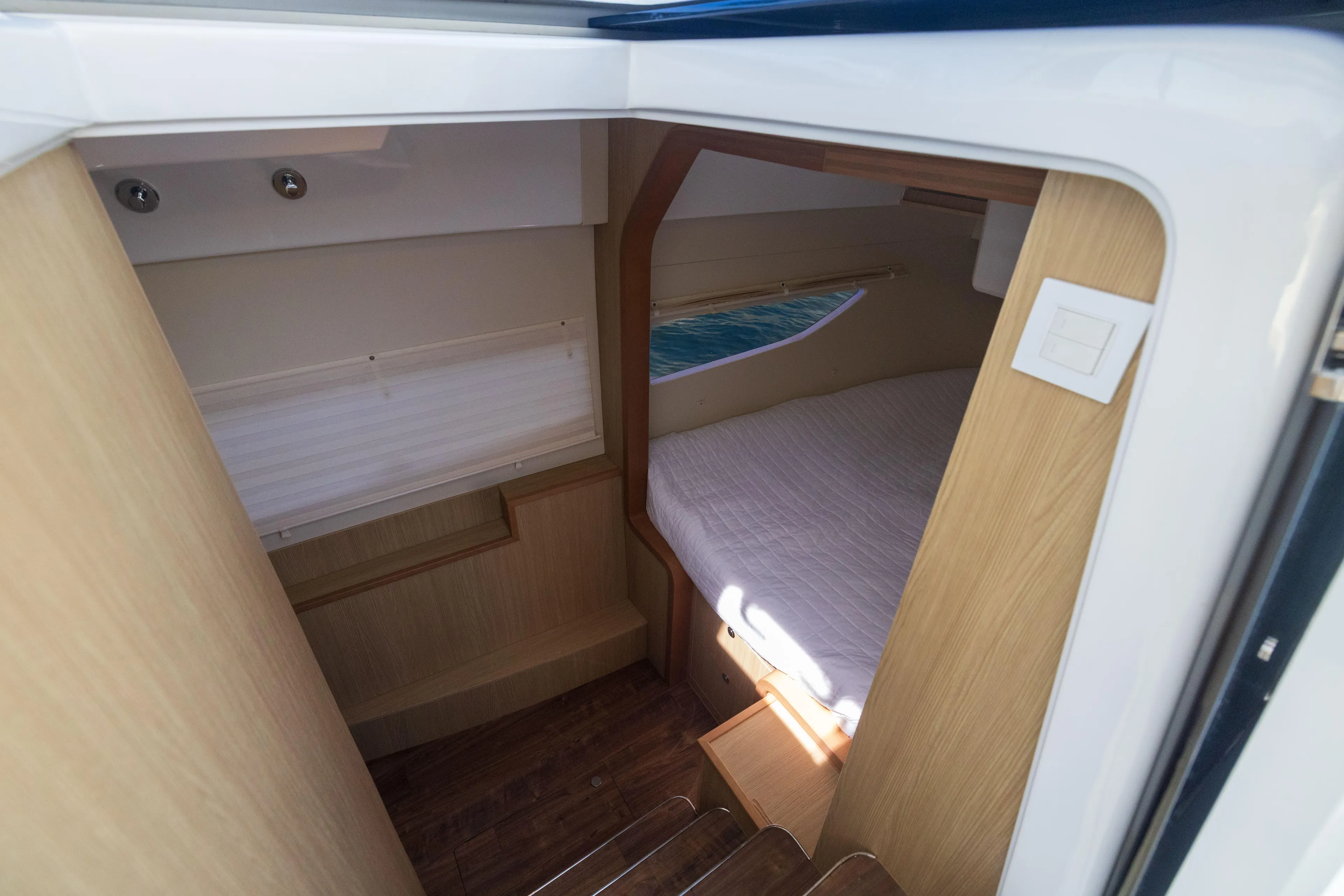  Yacht Photos Pics Interior cabin of 2019 Aquila 36 Sport boat with wooden finish and cozy bed.