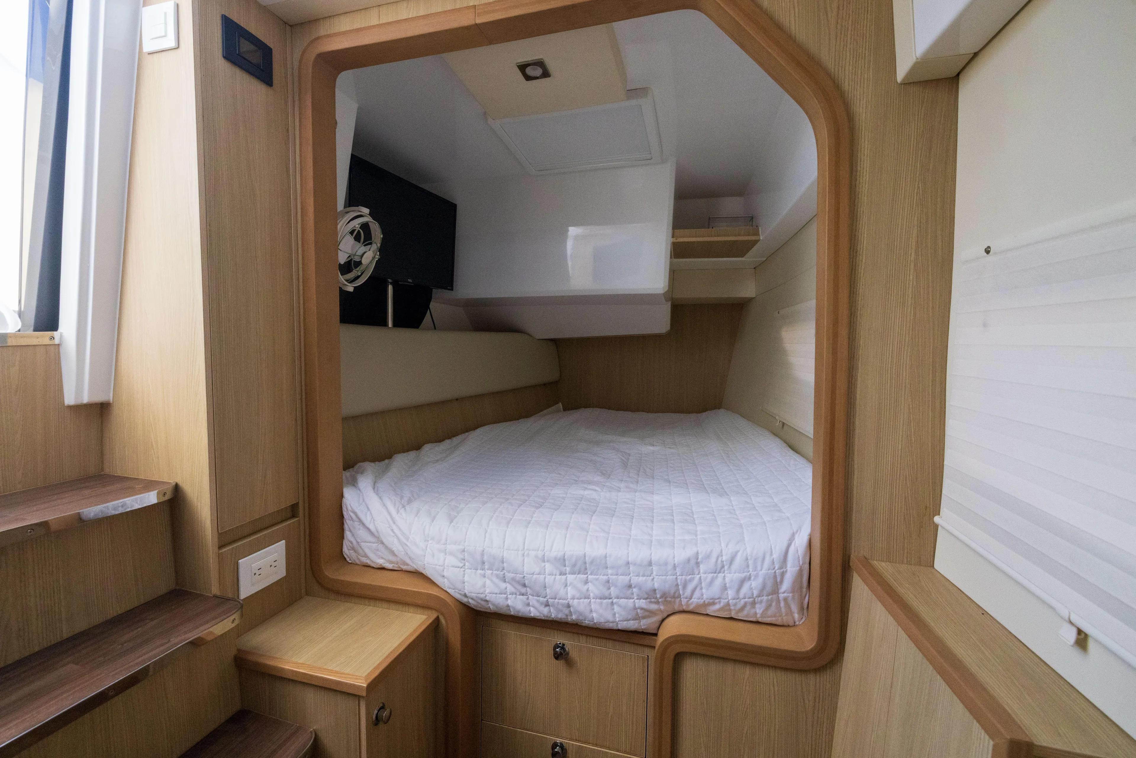  Yacht Photos Pics Cozy cabin interior of 2019 Aquila 36 Sport with a comfortable bed and wooden accents.