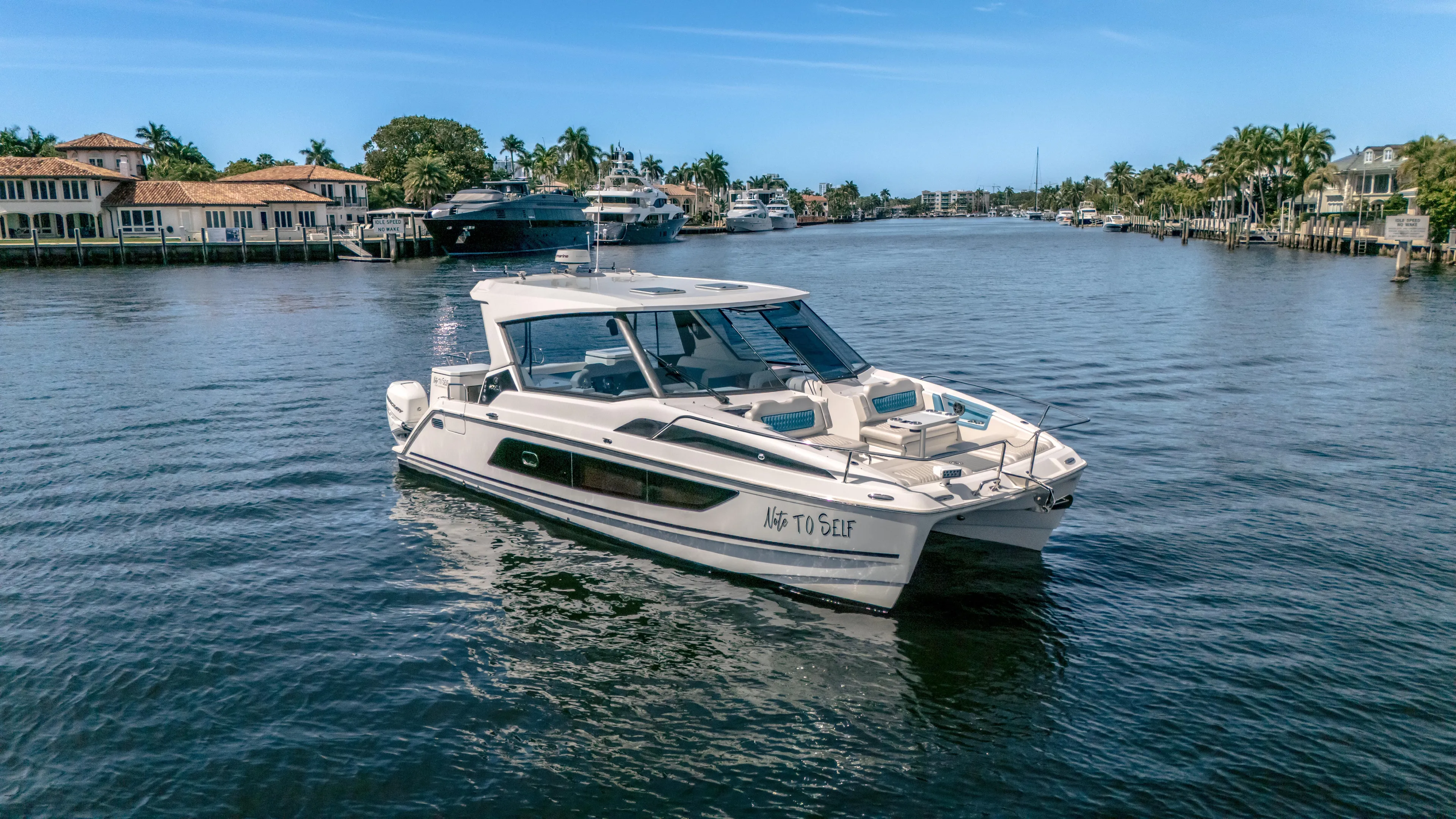  Yacht Photos Pics Aquila 36 Sport 2019 yacht cruising on a scenic waterway with luxury homes.