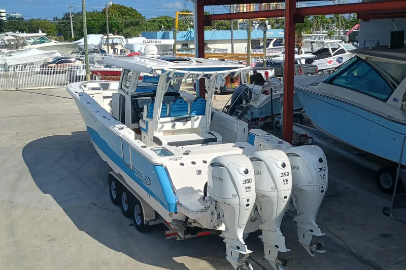 360-105 Yacht Photos Pics 2026 Robalo R360 Center Console boat with triple Yamaha 350 engines in a marina.