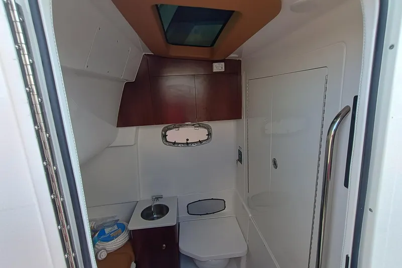 360-105 Yacht Photos Pics Interior of 2026 Robalo R360 Center Console boat bathroom with sink and toilet.