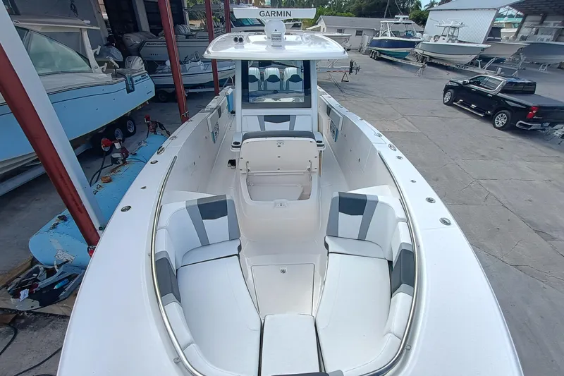 360-105 Yacht Photos Pics 2026 Robalo R360 Center Console boat with spacious seating and modern design in a marina.