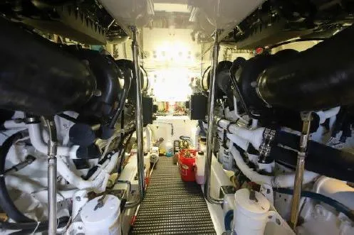 Bucket List Yacht Photos Pics Engine room of 2013 Hatteras GT54 yacht, showcasing dual engines and mechanical components.