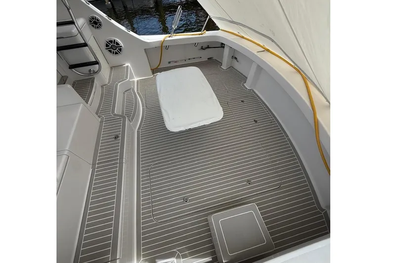 Bucket List Yacht Photos Pics Spacious deck of 2013 Hatteras GT54 yacht with striped flooring and seating area.