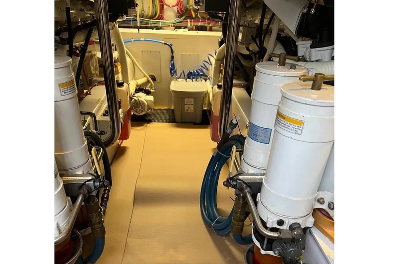 Bucket List Yacht Photos Pics Engine room of 2013 Hatteras GT54 yacht, featuring mechanical components and piping.