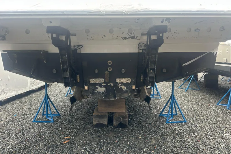 World Wide Yacht Photos Pics Rear view of a 2020 Prestige 460 boat on stands, showing the hull and propeller area.