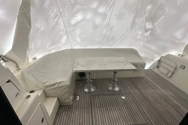 World Wide Yacht Photos Pics Interior of 2020 Prestige 460 yacht with covered seating and table on deck.