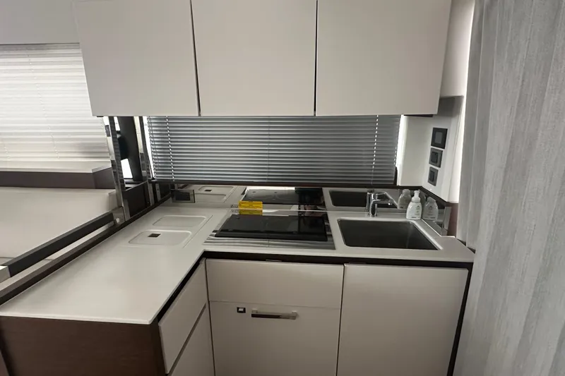 World Wide Yacht Photos Pics Modern kitchen in a 2020 Prestige 460 yacht with sleek cabinetry and appliances.