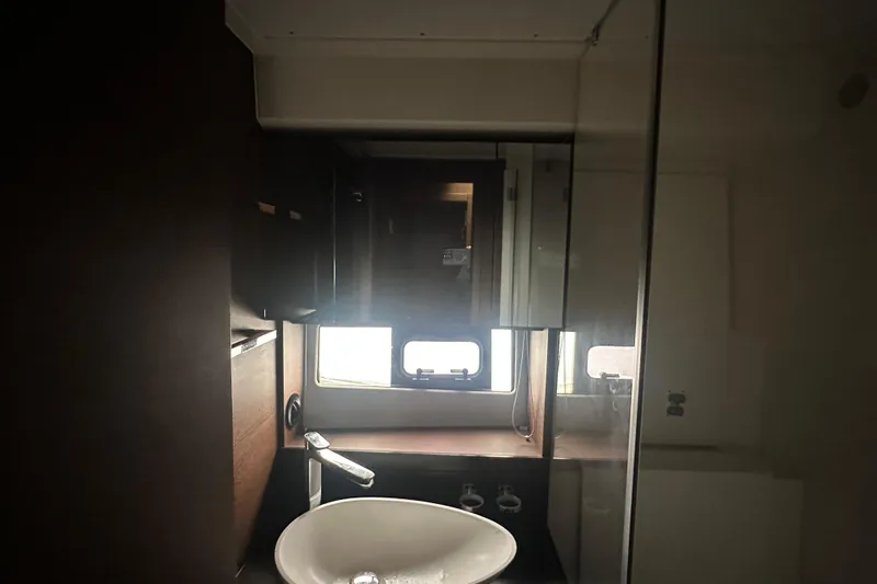 World Wide Yacht Photos Pics Modern bathroom interior of 2020 Prestige 460 yacht with sleek sink and window.