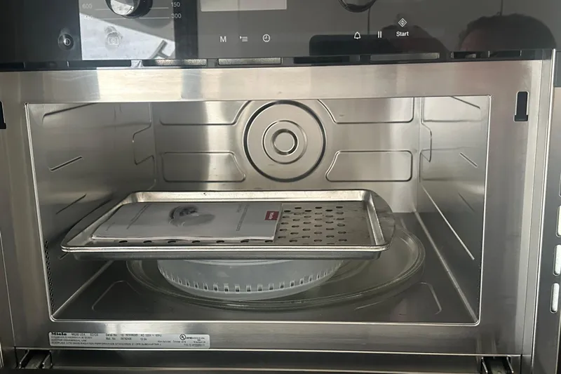 World Wide Yacht Photos Pics Interior of a 2020 Prestige 460 oven with a tray and manual inside.