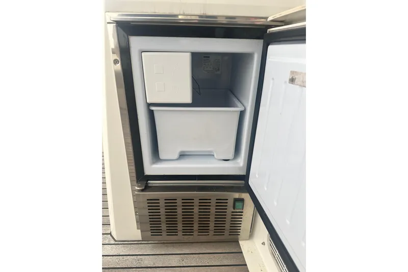 World Wide Yacht Photos Pics Open freezer compartment on a 2020 Prestige 460 yacht, showcasing interior storage space.