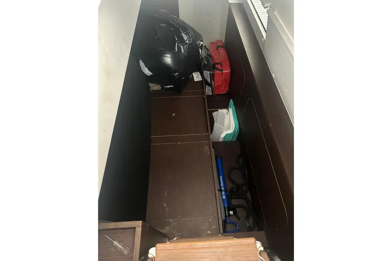 World Wide Yacht Photos Pics Storage compartment in a 2020 Prestige 460 yacht with various items organized neatly.