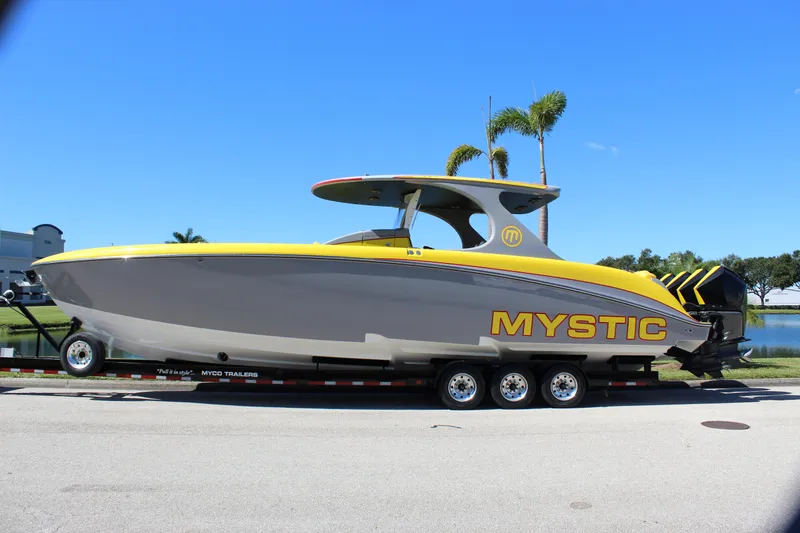  Yacht Photos Pics 2021 Mystic M4200 powerboat on trailer, featuring sleek yellow and gray design.