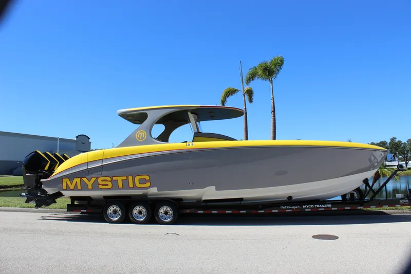  Yacht Photos Pics 2021 Mystic M4200 powerboat on trailer, featuring sleek design and vibrant yellow accents.
