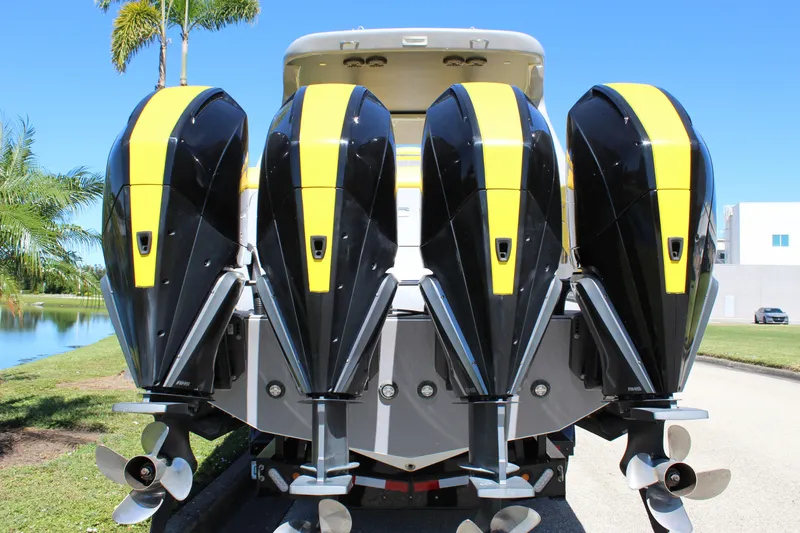  Yacht Photos Pics Four powerful outboard motors on a 2021 Mystic M4200 boat, featuring sleek black and yellow design.