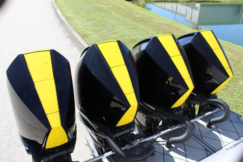  Yacht Photos Pics Four yellow and black outboard motors on a 2021 Mystic M4200 boat.