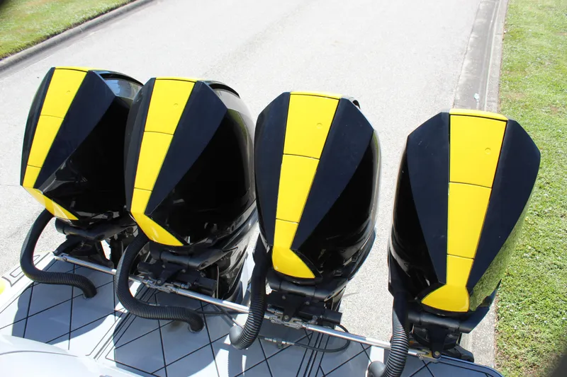  Yacht Photos Pics Four black and yellow outboard motors on a 2021 Mystic M4200 boat.