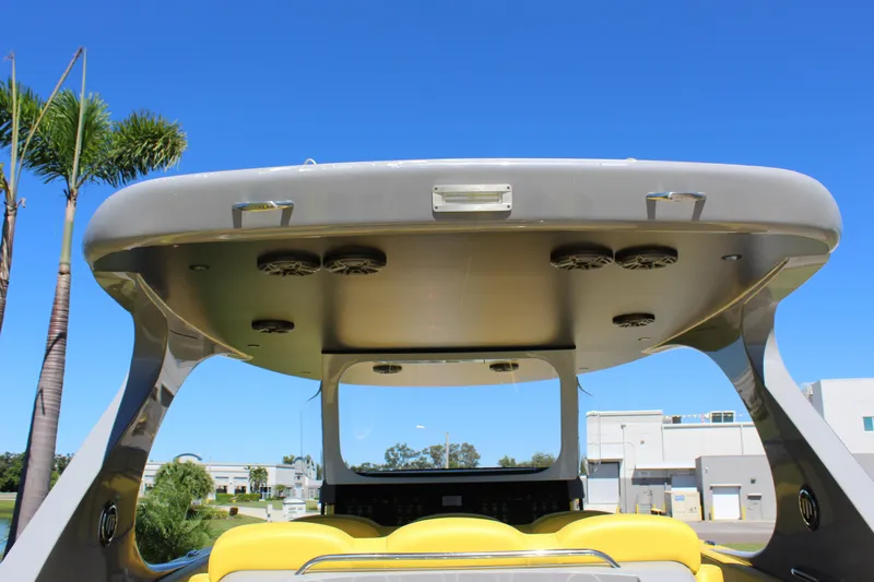  Yacht Photos Pics 2021 Mystic M4200 boat with sleek design, yellow seating, and modern canopy speakers.