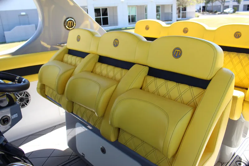  Yacht Photos Pics Yellow leather seats in a 2021 Mystic M4200 boat interior.
