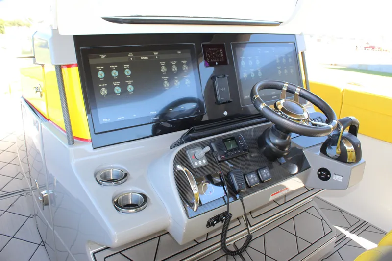  Yacht Photos Pics Control panel of 2021 Mystic M4200 boat with steering wheel and digital displays.