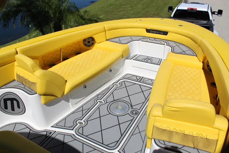  Yacht Photos Pics Yellow interior of 2021 Mystic M4200 boat with quilted seating and geometric flooring.