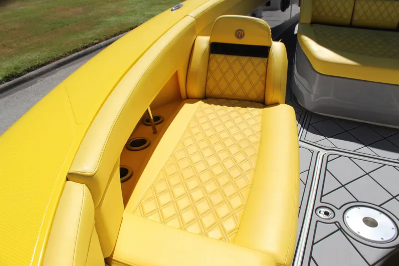  Yacht Photos Pics Yellow quilted seating on 2021 Mystic M4200 boat, featuring stylish design and cup holders.