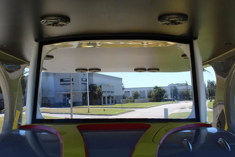  Yacht Photos Pics Interior view of 2021 Mystic M4200 boat with street and buildings visible outside.